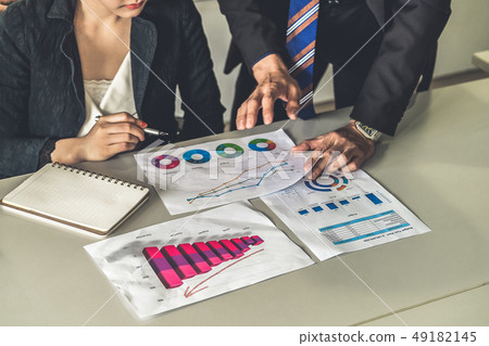 Business people working with business report. Business people working with business report. 49182145