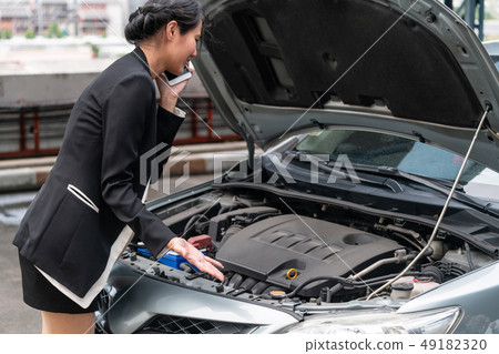Woman whose car breakdown call for repair service. 49182320