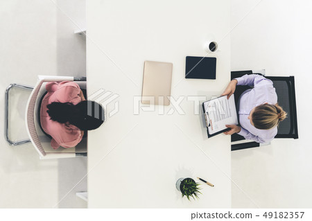 Two young business women meeting for interview. Two young business women meeting for interview. 49182357