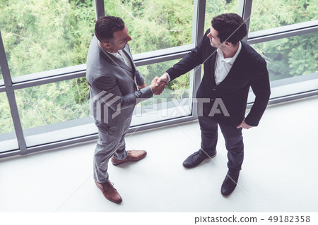 Businessmen handshake business deal in office. Businessmen handshake business deal in office. 49182358
