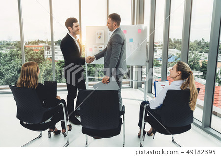 Businesswomen and businessmen in group meeting. Businesswomen and businessmen in group meeting. 49182395