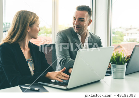 Businessman and businesswoman working in office. Businessman and businesswoman working in office. 49182398