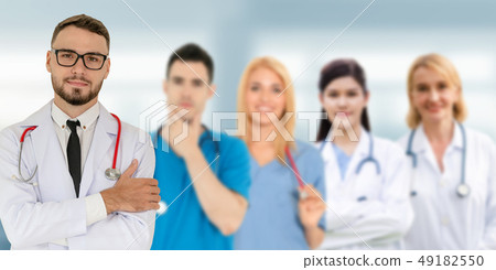 Doctor working in hospital with other doctors. Doctor working in hospital with other doctors. 49182550