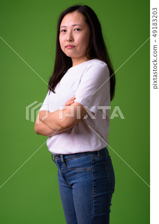 Young Chinese woman against green background 49183203