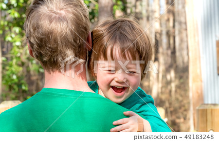 Happy toddler boy being held Happy toddler boy being held 49183248