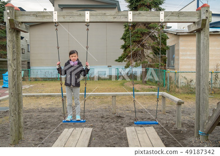 A child on a swing A child on a swing 49187342