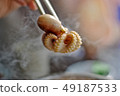 Pick up the steaming delicious octopus with chopsticks. 49187533