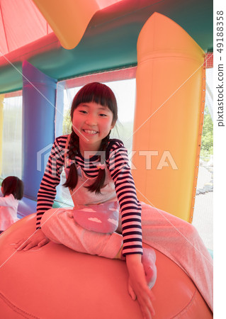 A child playing with amusement park air playground equipment A child playing with amusement park air playground equipment 49188358