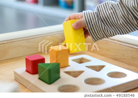 Baby playing a good shape game for brain development Baby playing a good shape game for brain development 49188546