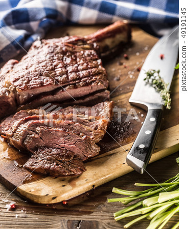 Freshly grilled tomahawk steak on slate plate with Freshly grilled tomahawk steak on slate plate with 49191145
