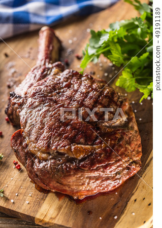 Freshly grilled tomahawk steak on slate plate with Freshly grilled tomahawk steak on slate plate with 49191189