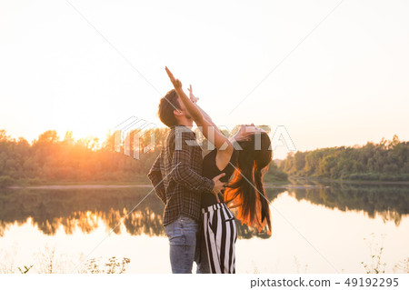 Kizomba, bachata, zouk and latin social dance concept - Man and woman dancing over nature background Kizomba, bachata, zouk and latin social dance concept - Man and woman dancing over nature background 49192295