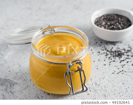 Vegan creamy cheddar cheese sauce with chia seeds Vegan creamy cheddar cheese sauce with chia seeds 49192641