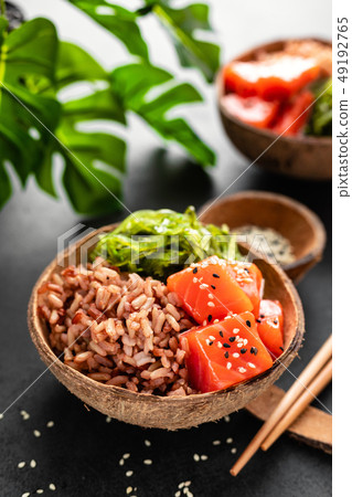 Poke bowl with raw salmon fish, chuka salad Poke bowl with raw salmon fish, chuka salad 49192765
