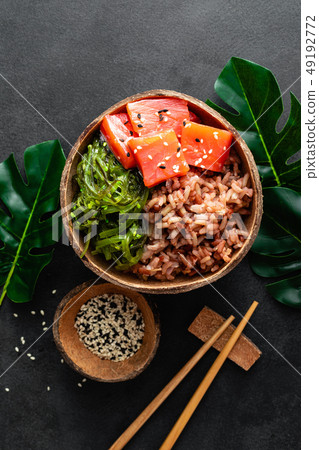 Poke bowl with raw salmon fish, chuka salad Poke bowl with raw salmon fish, chuka salad 49192772