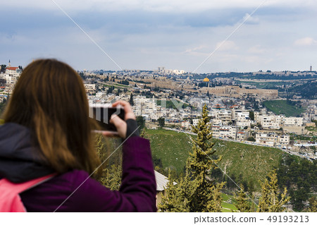 Woman taking photograph with smartphone at 49193213