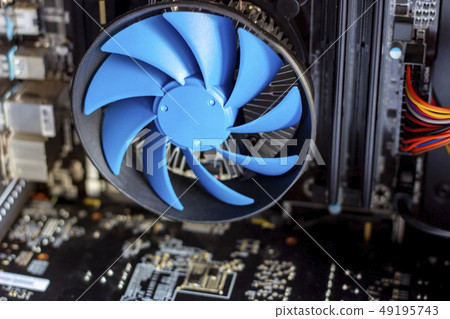 Blue cooler fan with motherboard inside computer Blue cooler fan with motherboard inside computer 49195743