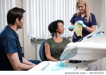 Dentist and his assitant working in private practice Dentist and his assitant working in private practice 49195839