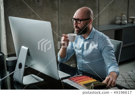 Middle-aged designer working in office Middle-aged designer working in office 49196617