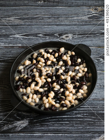 Black and white baked beans in a pan. Black and white baked beans in a pan. 49196620