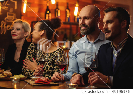 Group of friends having fun talk behind bar counter in a cafe 49196926