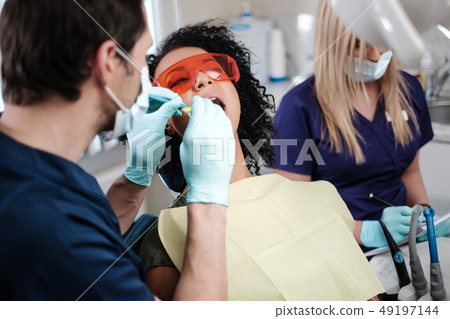 Dentist and his assitant working in private practice. 49197144