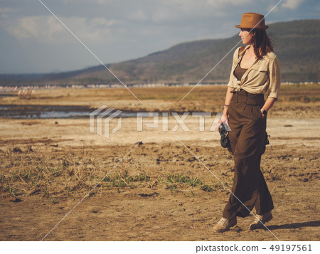 Beautiful woman with binoculars at savanna in Kenya 49197561