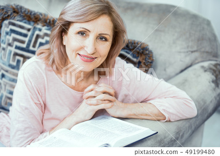An Elderly Woman of European Appearance Prays Near the Bible. An Elderly Woman of European Appearance Prays Near the Bible. 49199480
