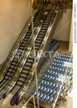 escalator and shopping carts in the shopping mall escalator and shopping carts in the shopping mall 49199855