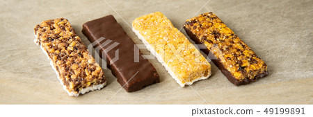 Various muesli bars on marble stone background 49199891