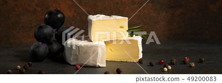 Cheese camembert or brie with dark grapes 49200083