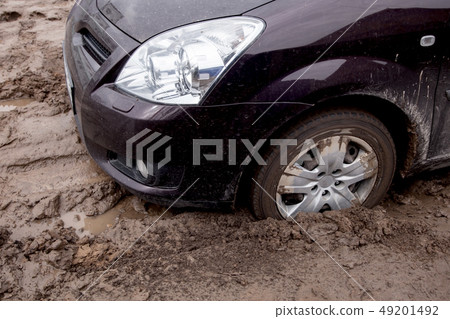 the car is stuck on a bad road in the mud the car is stuck on a bad road in the mud 49201492