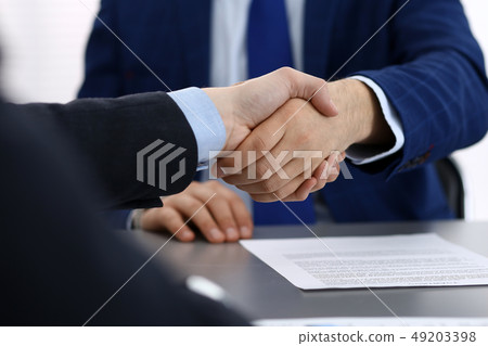 Business people shaking hands, finishing up a papers signing. Meeting, agreement and lawyer 49203398