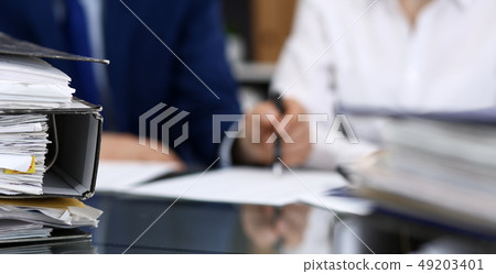 Binders with papers are waiting to be processed with bookkeeper. Internal Revenue Service inspector Binders with papers are waiting to be processed with bookkeeper. Internal Revenue Service inspector 49203401
