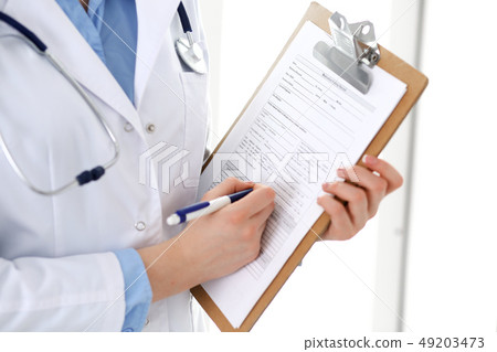 Female doctor using medical form on clipboard closeup. Physicianat work in hospital or clinic 49203473
