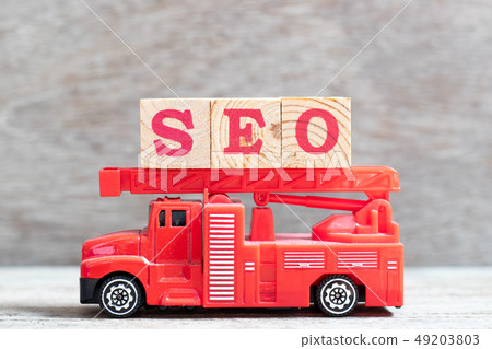 Red fire truck hold letter block in word SEO 49203803