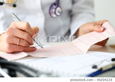 Doctor hands with cardiogram chart on clipboard pad Doctor hands with cardiogram chart on clipboard pad 49204228