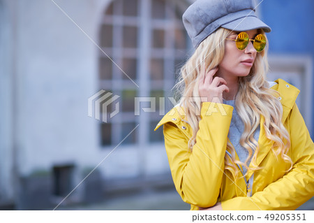 Blonde girl in a yellow raincoat Blonde girl in a yellow raincoat 49205351