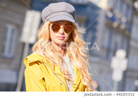 Blonde girl in a yellow raincoat Blonde girl in a yellow raincoat 49205352