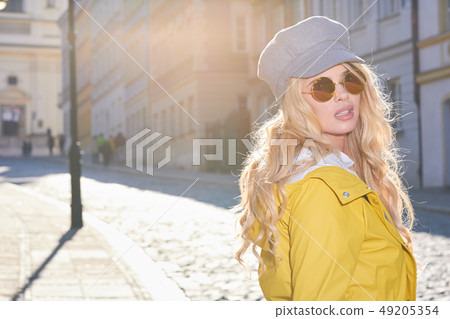 Blonde girl in a yellow raincoat Blonde girl in a yellow raincoat 49205354