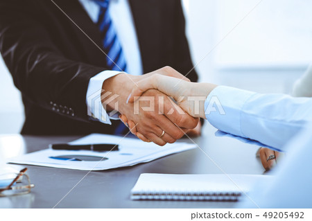 Business people shaking hands, finishing up a meeting 49205492