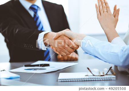 Business people shaking hands, finishing up a meeting Business people shaking hands, finishing up a meeting 49205508