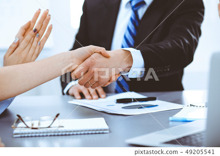 Business people shaking hands, finishing up a meeting Business people shaking hands, finishing up a meeting 49205541