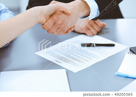 Business people shaking hands, finishing up a meeting Business people shaking hands, finishing up a meeting 49205565