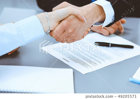 Business people shaking hands, finishing up a meeting Business people shaking hands, finishing up a meeting 49205571