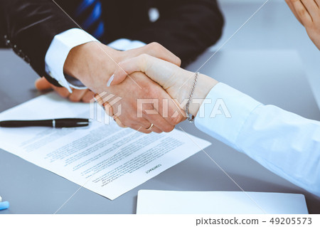 Business people shaking hands, finishing up a meeting Business people shaking hands, finishing up a meeting 49205573