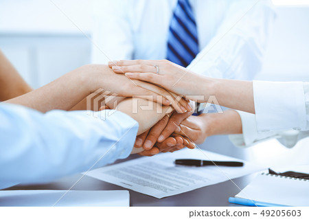Business people group joining hands and representing concept of friendship and teamwork 49205603