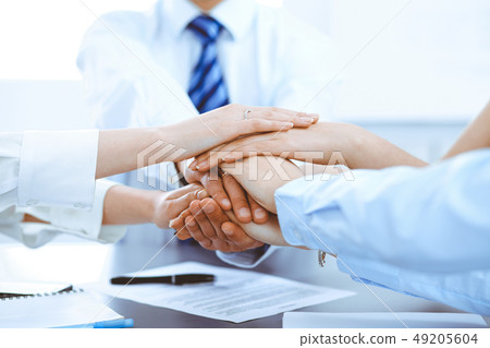 Business people group joining hands and representing concept of friendship and teamwork Business people group joining hands and representing concept of friendship and teamwork 49205604