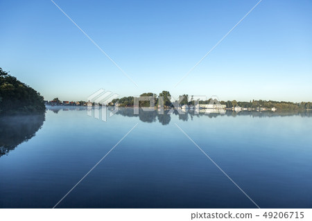 Reflection of a harbour in itylake the Nieuwe Meer 49206715