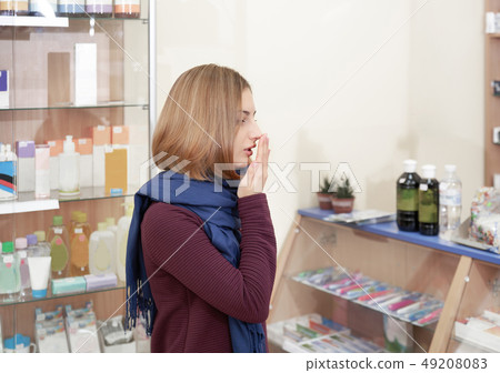 Sick woman seeking medicines from illness in drugstore. 49208083